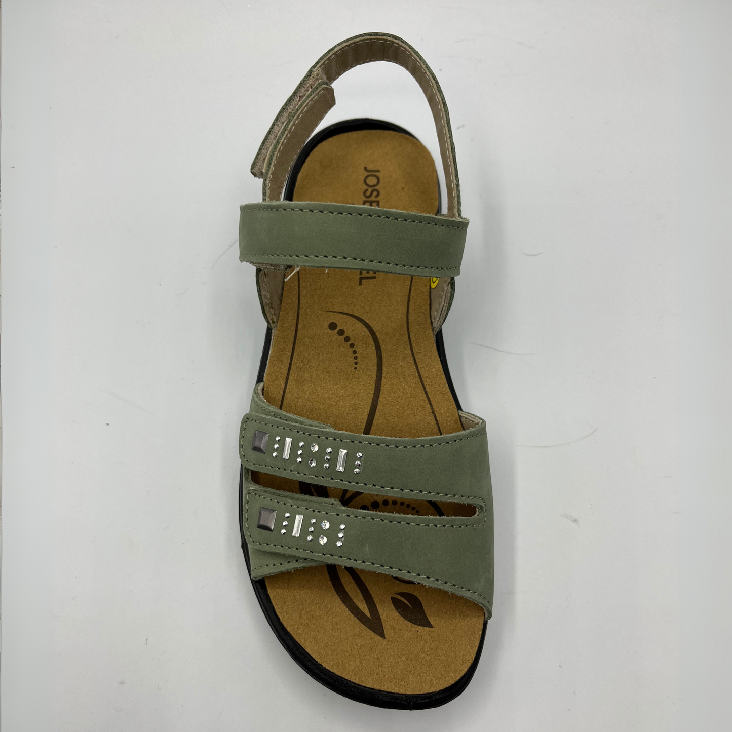 Top view of a green nubuck leather sandal with 4 adjustable hook and loop straps, a contoured footbed and a black outsole.
