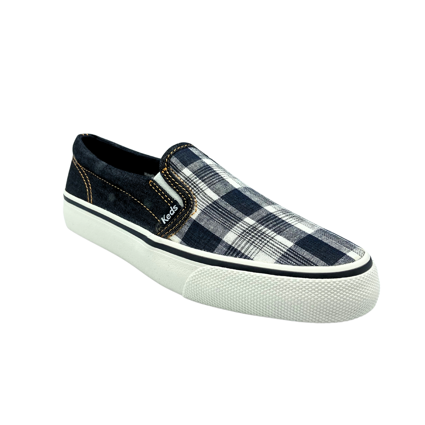 Angled front view of a slip on canvas sneaker in a black denim plaid. Rubber outsole is white with a black stripe around the top