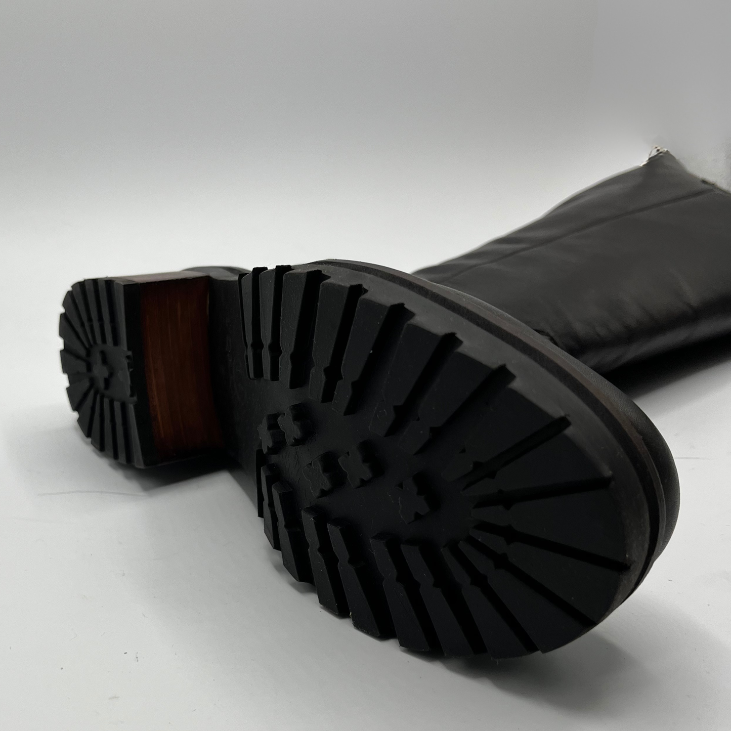 Close-up of black rubber boots with a white background
