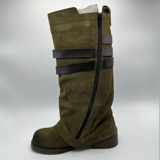 Green knee-high boot with black straps on a white background