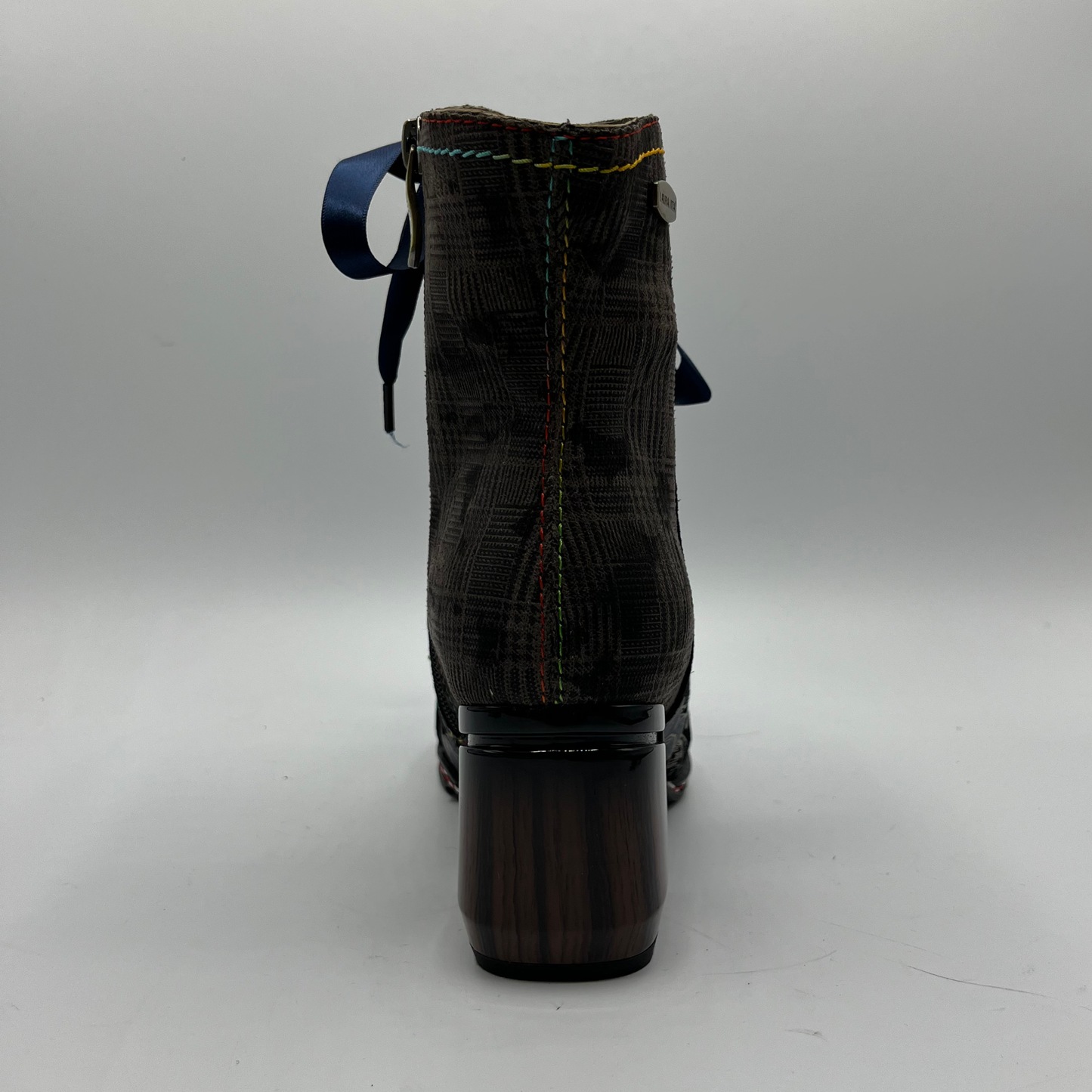 Boot with a block heel on a gray background