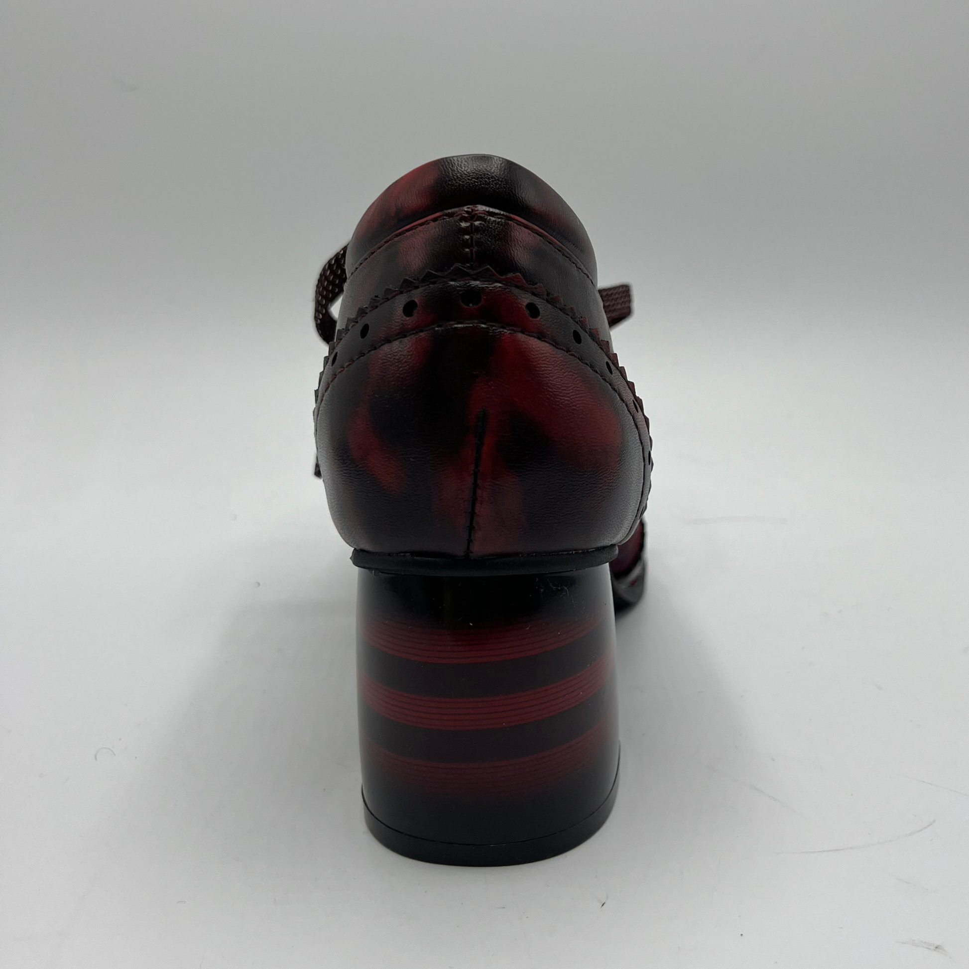 Black and red patterned shoe on a white background