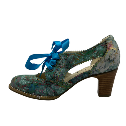 Left facing view of patterned leather oxford with blue ribbon laces and stacked heel.