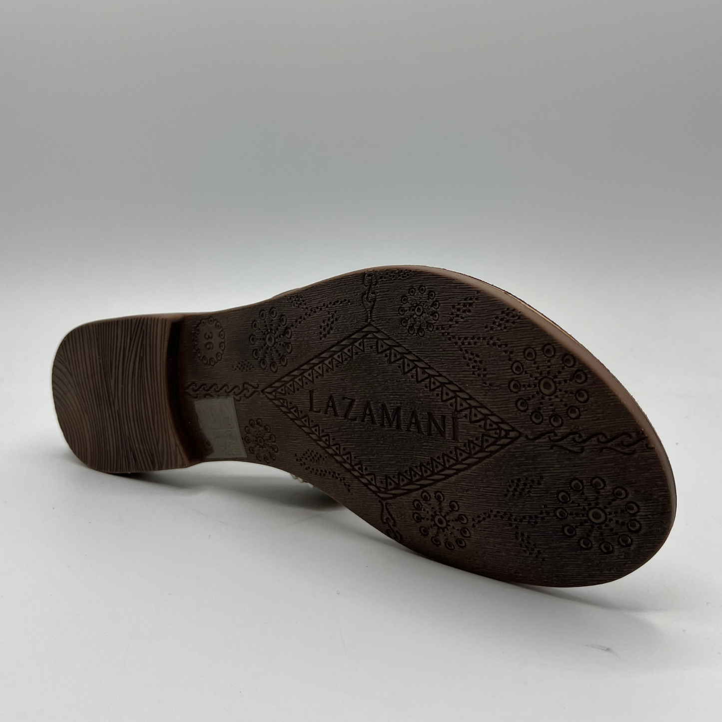 Bottom view of a beaded strapped, thong sandal with a suede wrapped footbed and lightweight rubber outsole.