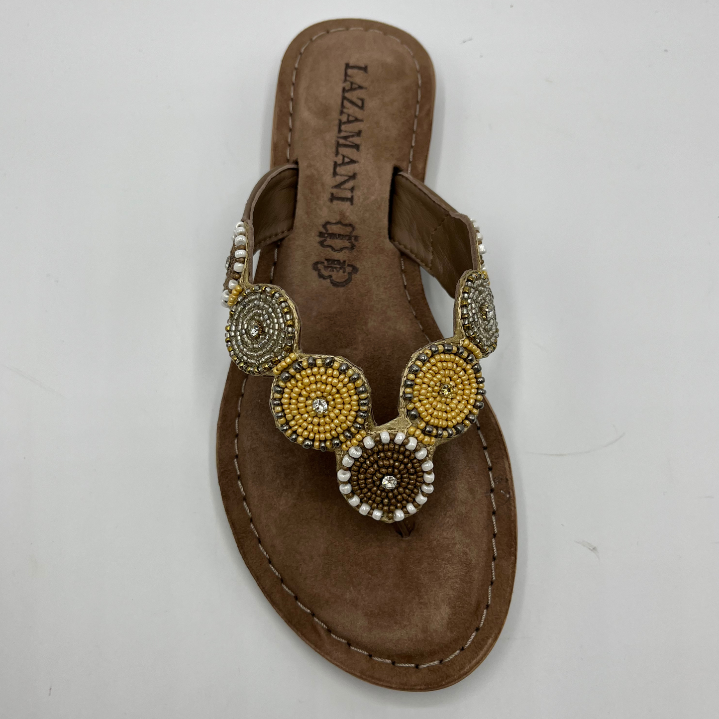 Top view of a beaded strapped, thong sandal with a suede wrapped footbed and lightweight rubber outsole.