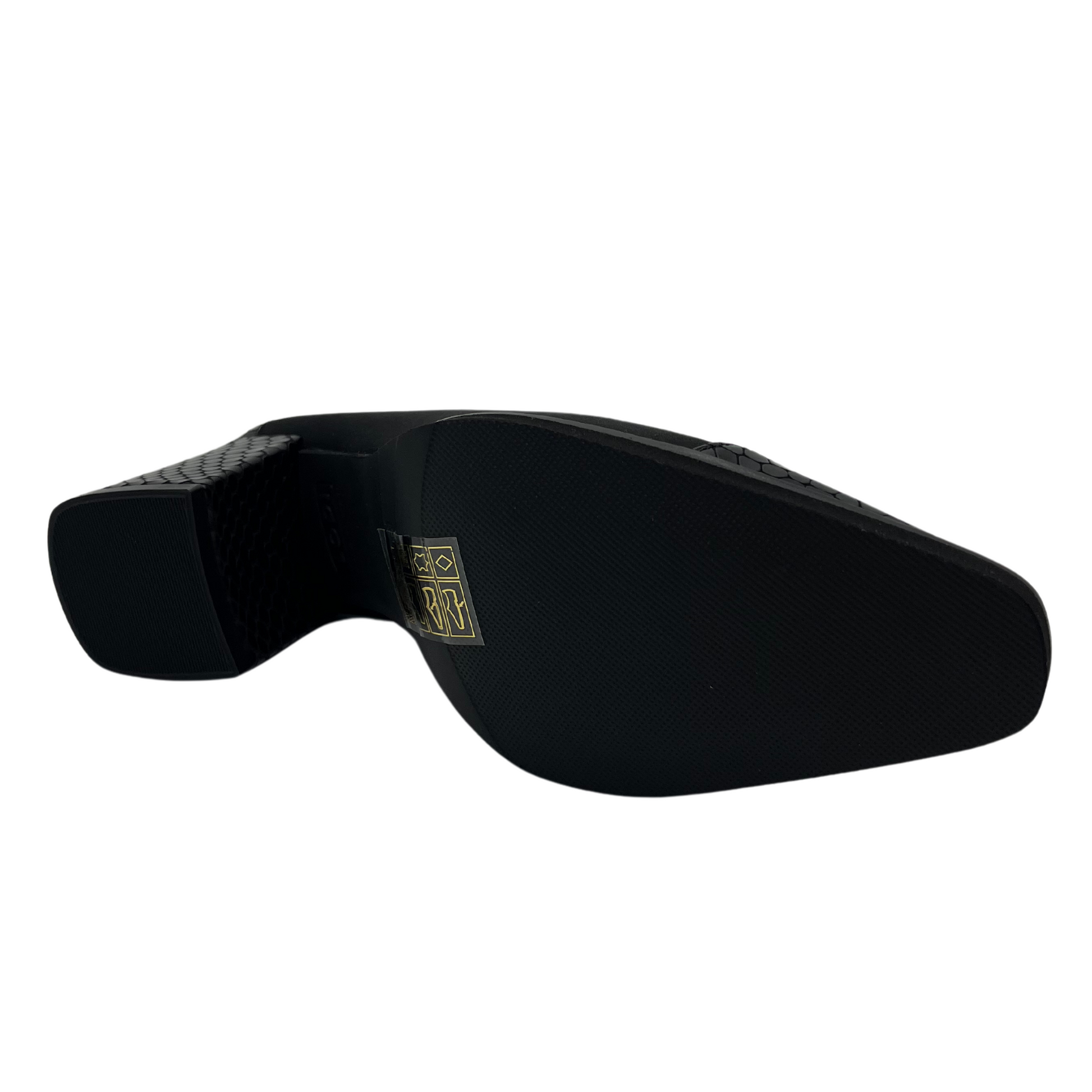 Bottom view of black suede pump with croc print toe cap and wrapped heel