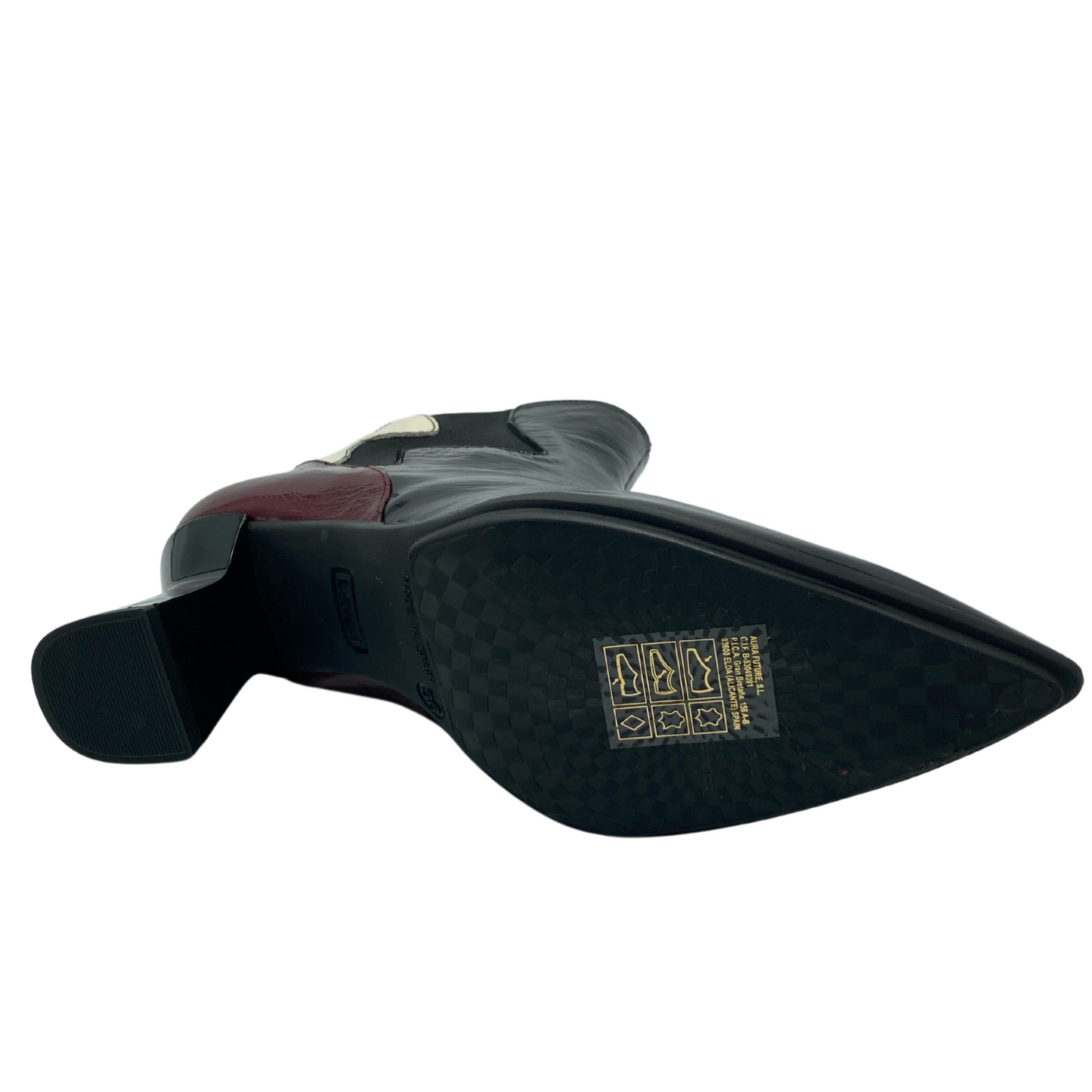 Bottom view of pointed toe, leather, ankle boot with black rubber sole