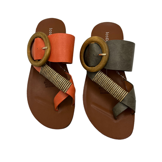 Top view of a pair of slip on sandals. One is orange and one is khaki. Both have a wooden buckle and bamboo wrap on the toe strap.