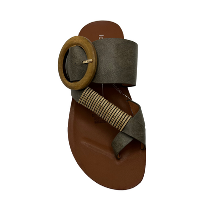Top view of khaki strapped slip on sandal. Featuring a wooden buckle and bamboo wrap on the toe strap.