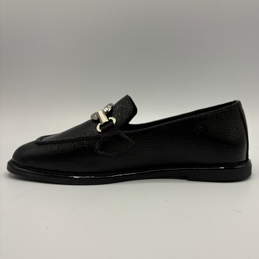 Left facing view of a black pebbled leather loafer with a silver accent on the toe box