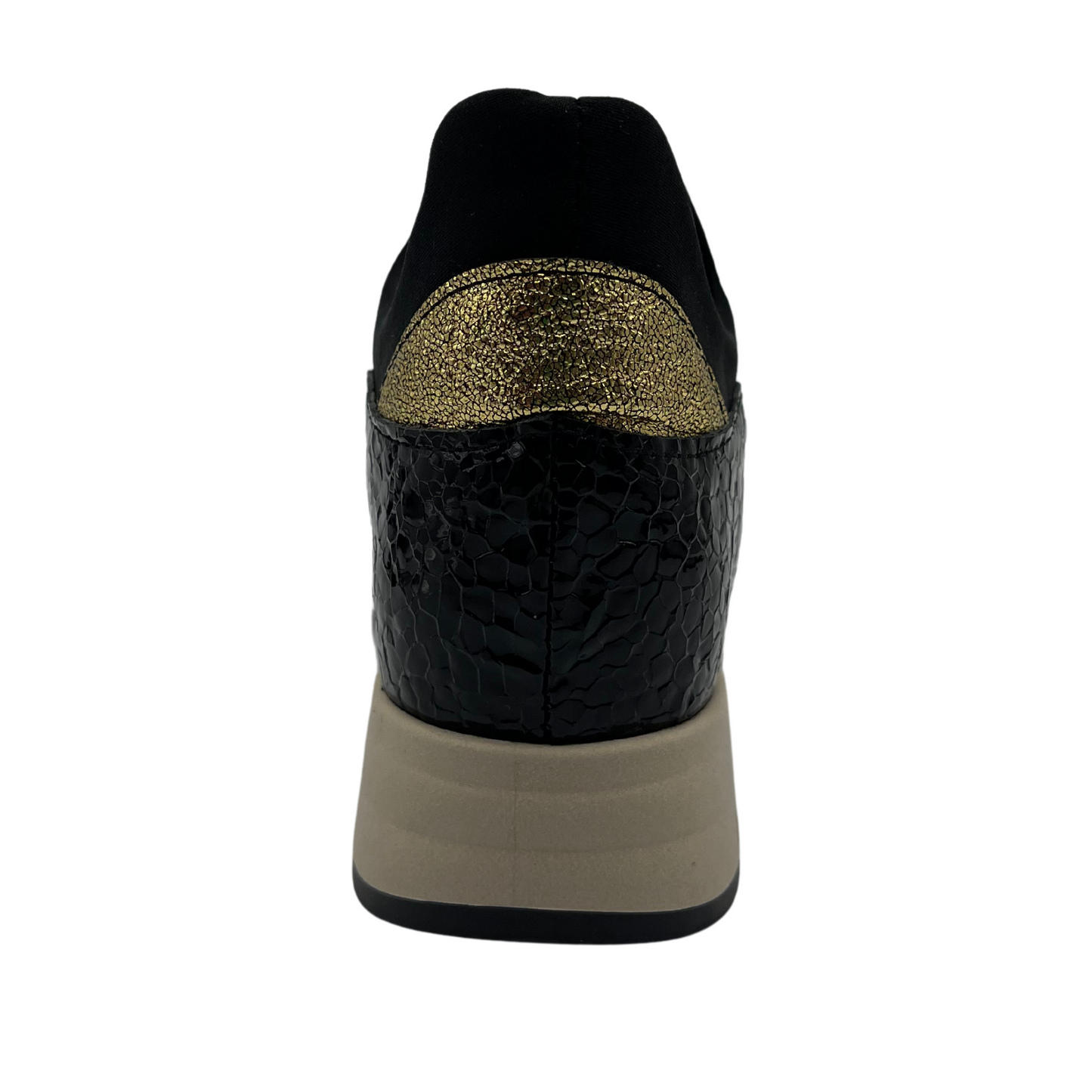 Back view of black hidden wedge sneakers with an elastic closure and beige outsole
