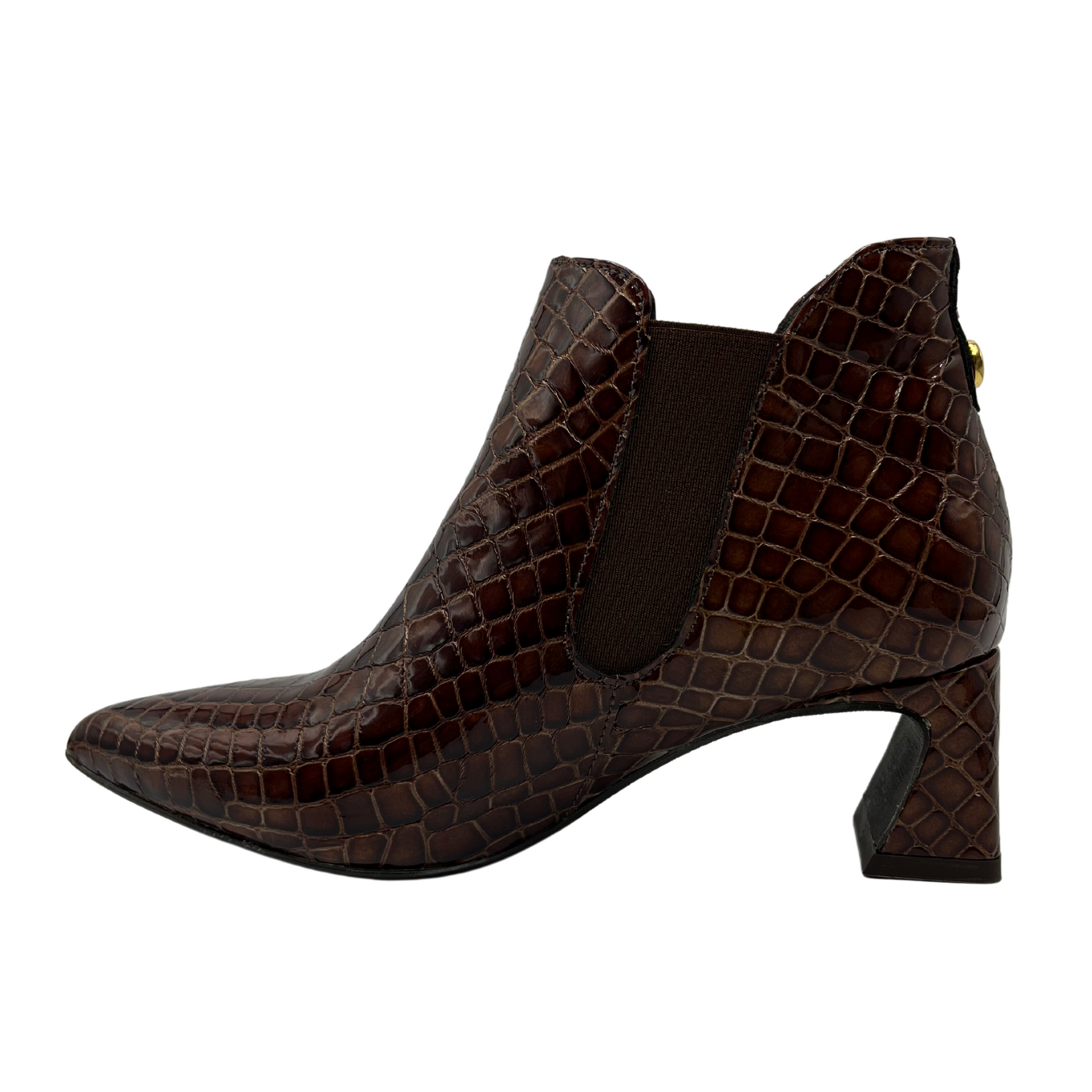 Left facing view of textured croc print leather bootie with a pointed toe and flared heel