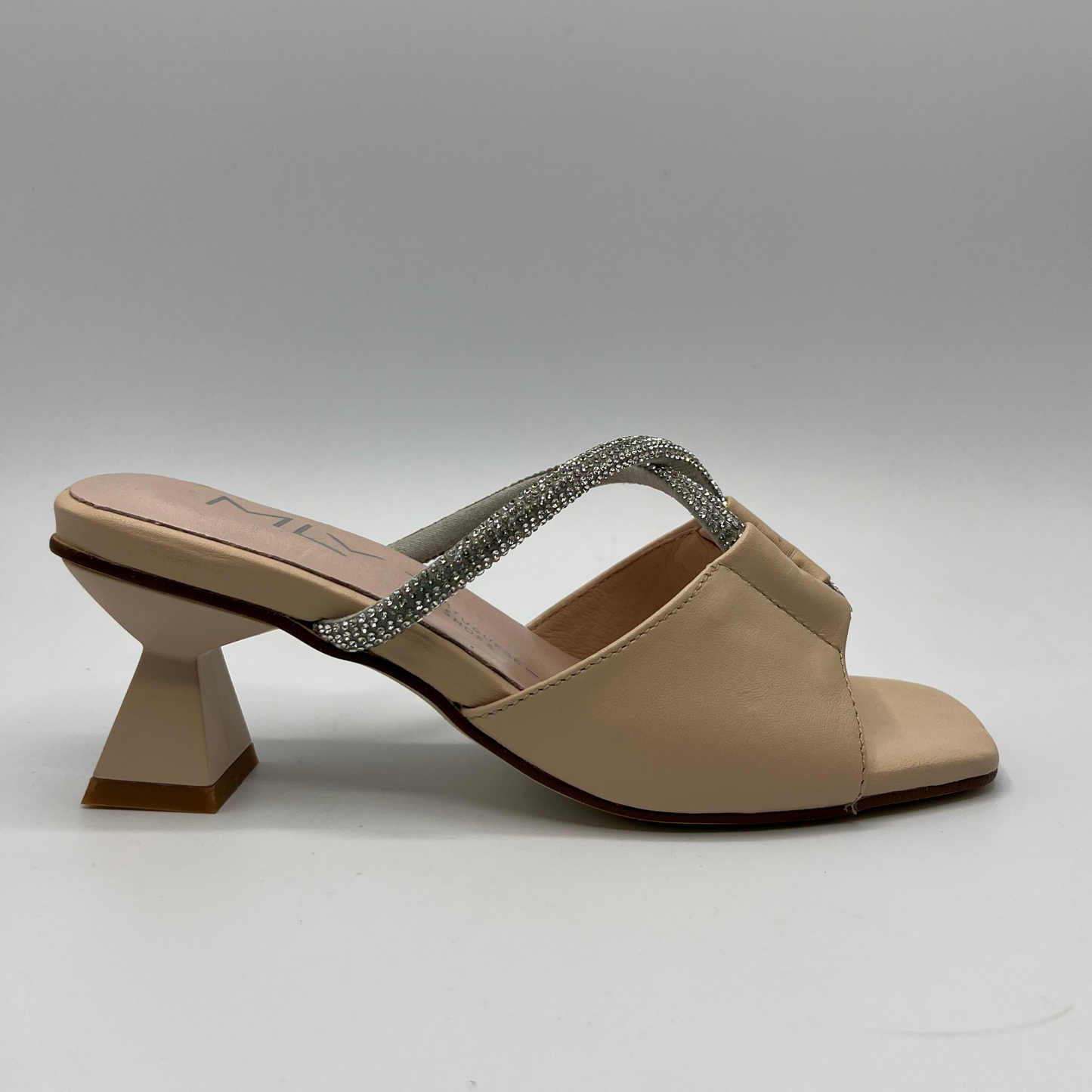 Right facing view of a beige leather sandal with a geometric flared heel, leather lining and a silver jewelled rope detail.
