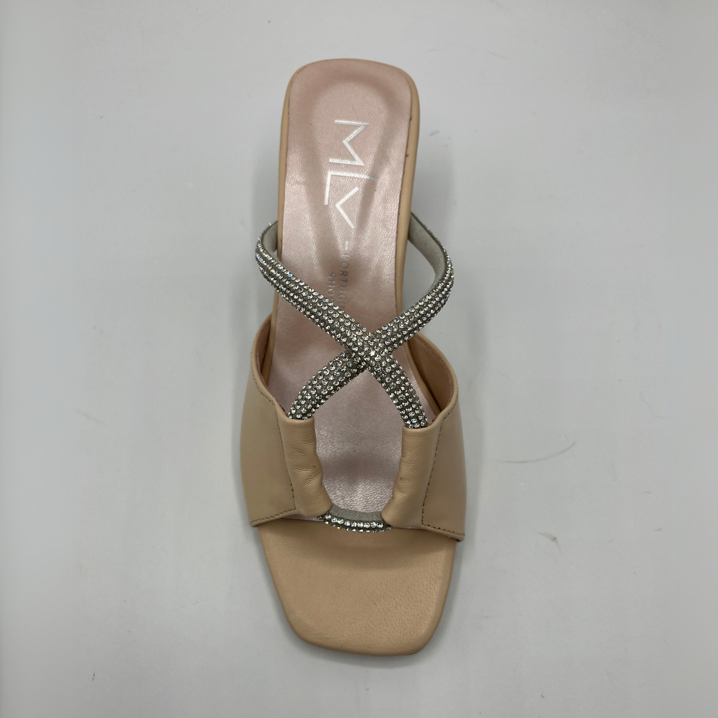 Top view of a beige leather sandal with a geometric flared heel, leather lining and a silver jewelled rope detail.