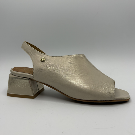 Shiny beige sandal with block heel on a gray background