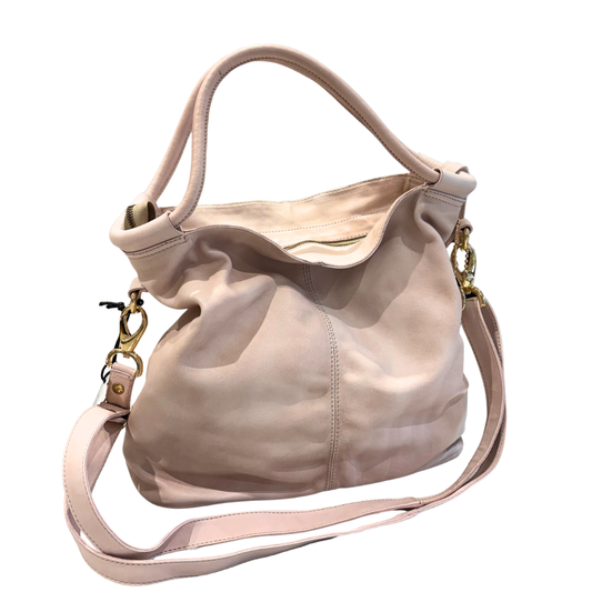 Soft pink handbag with a strap on a white background