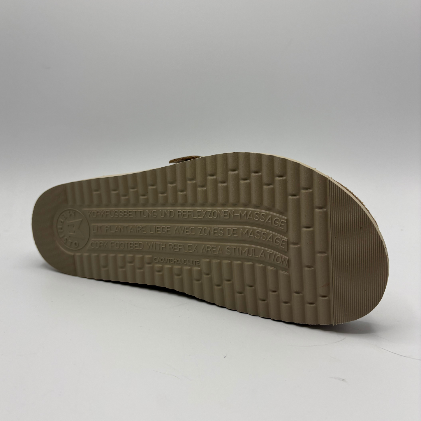 Brown sandal sole with brand name on a gray background
