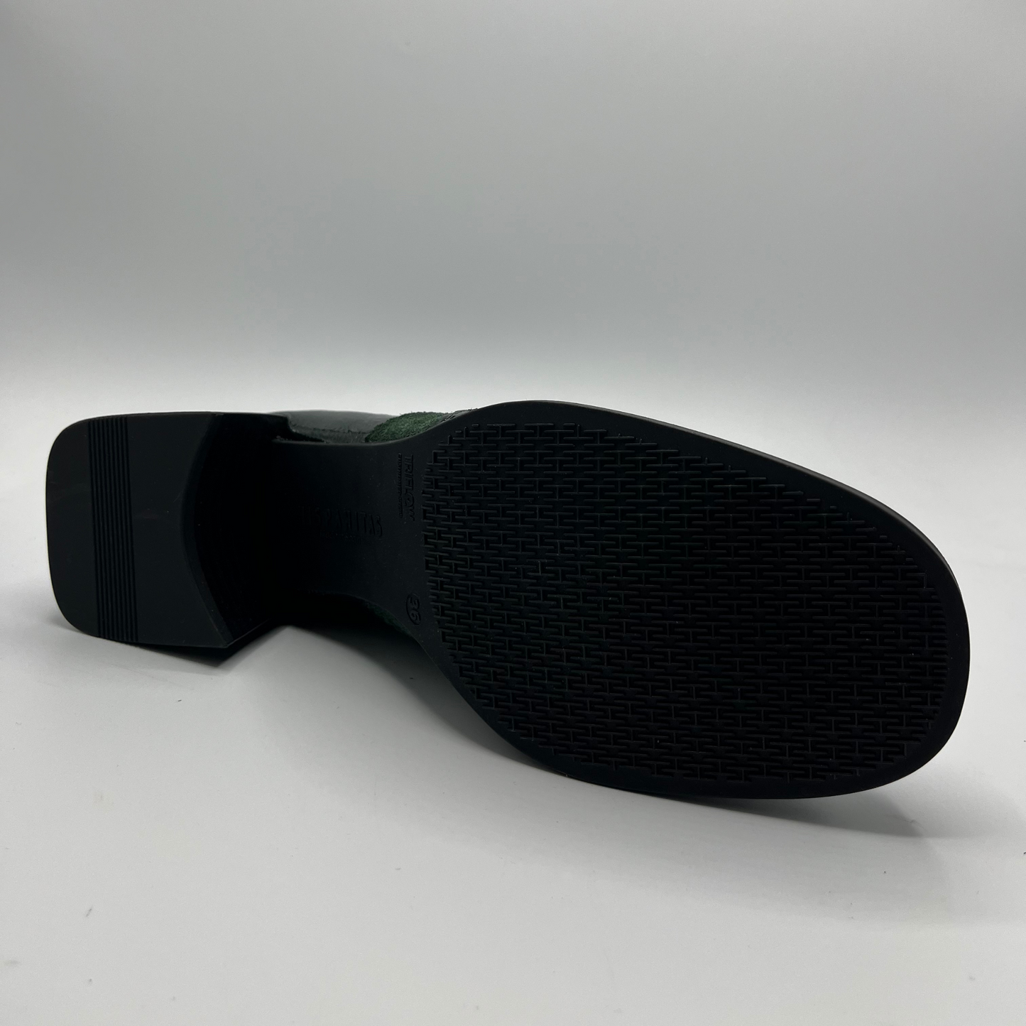 Black shoe sole on a light gray background