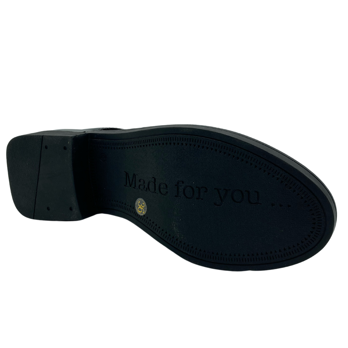 Bottom view of black rubber sole of leather boot with block heel