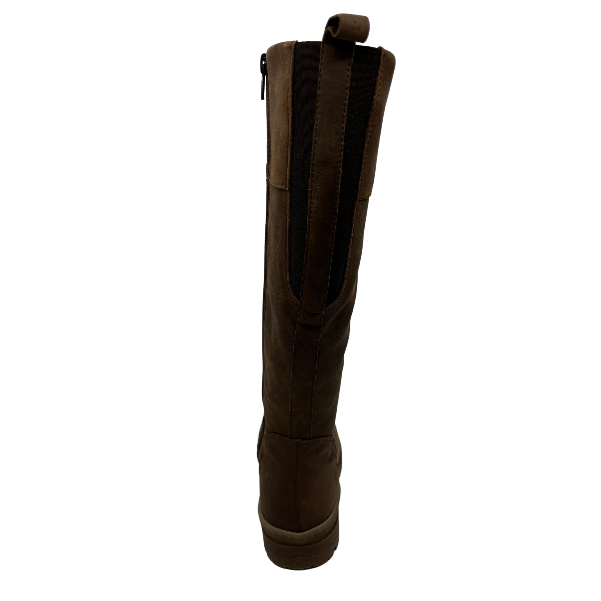 Back view of brown leather knee height boot with rubber lug outsole, inside zipper and pull on tab