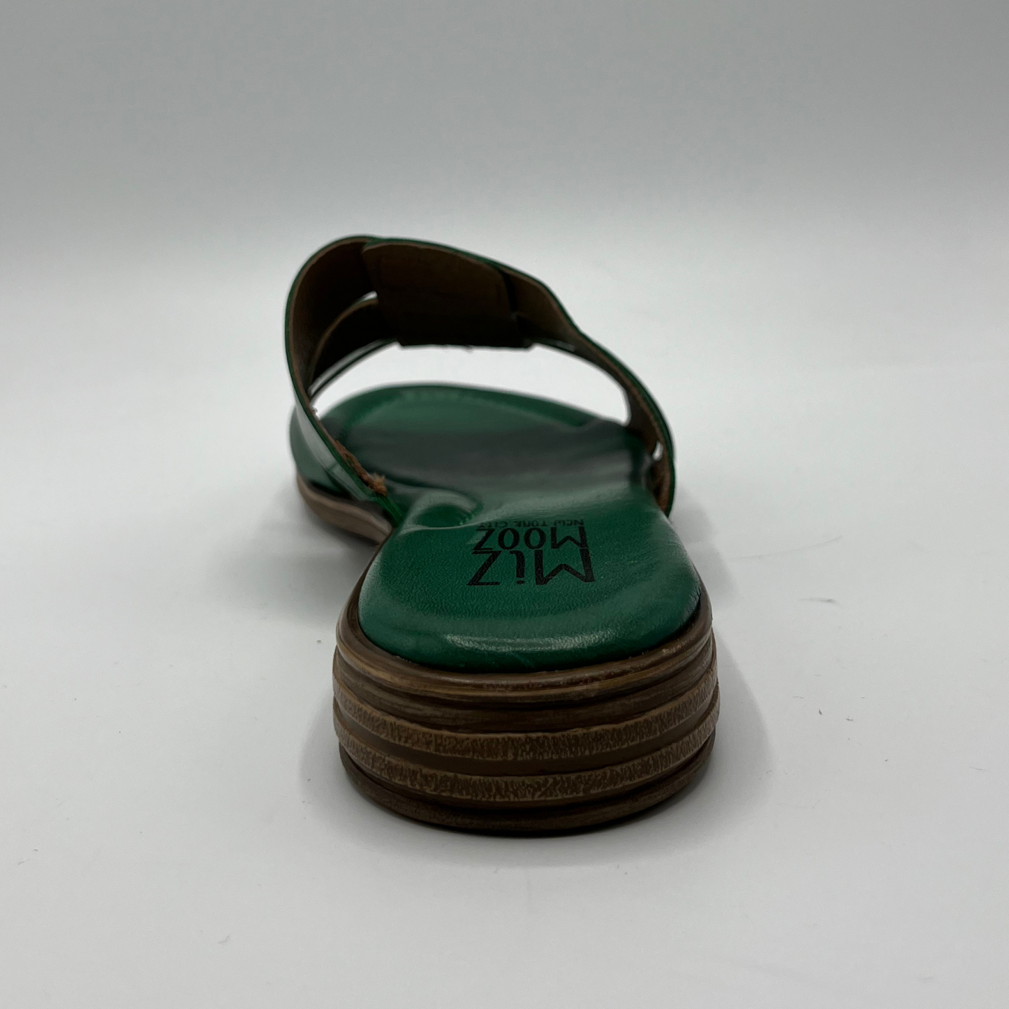 Back view of a leather slip on sandal in emerald green with a low stacked heel, and cushioned leather lined insole