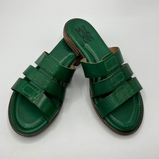 Top view of a pair leather slip on sandals in emerald green with a low stacked heel, and cushioned leather lined insole