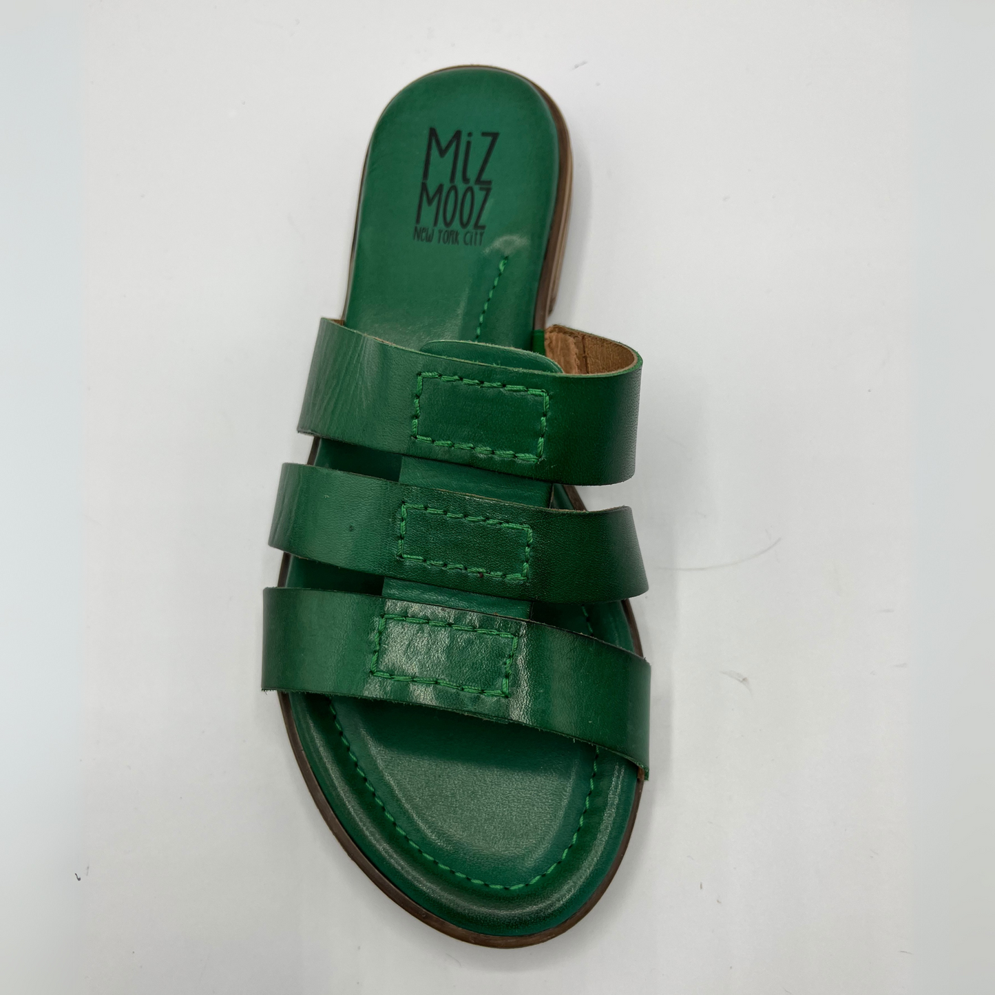 Top view of a leather slip on sandal in emerald green with a low stacked heel, and cushioned leather lined insole