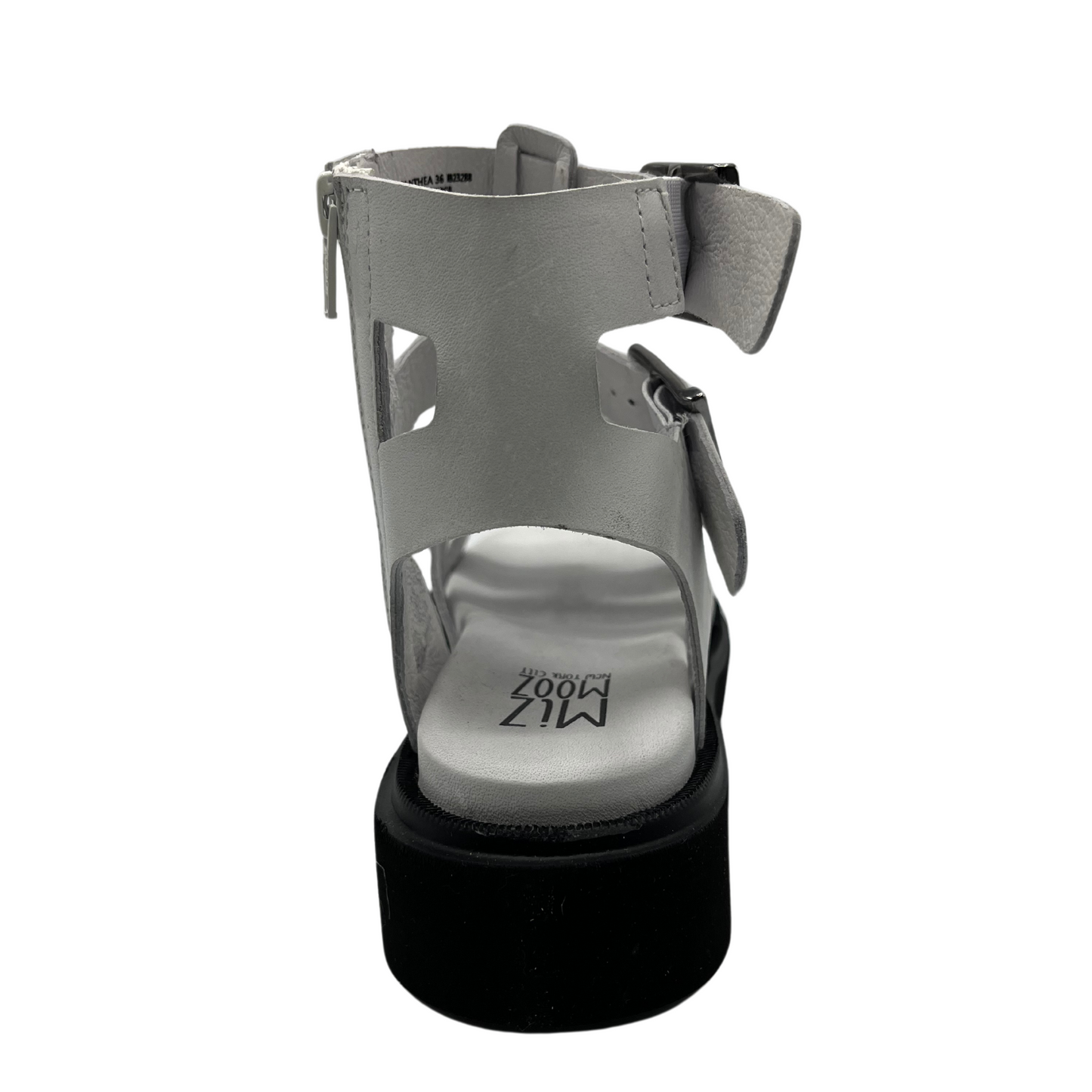 Back view of white leather gladiator sandal with black rubber outsole. Lined footbed and double buckle straps