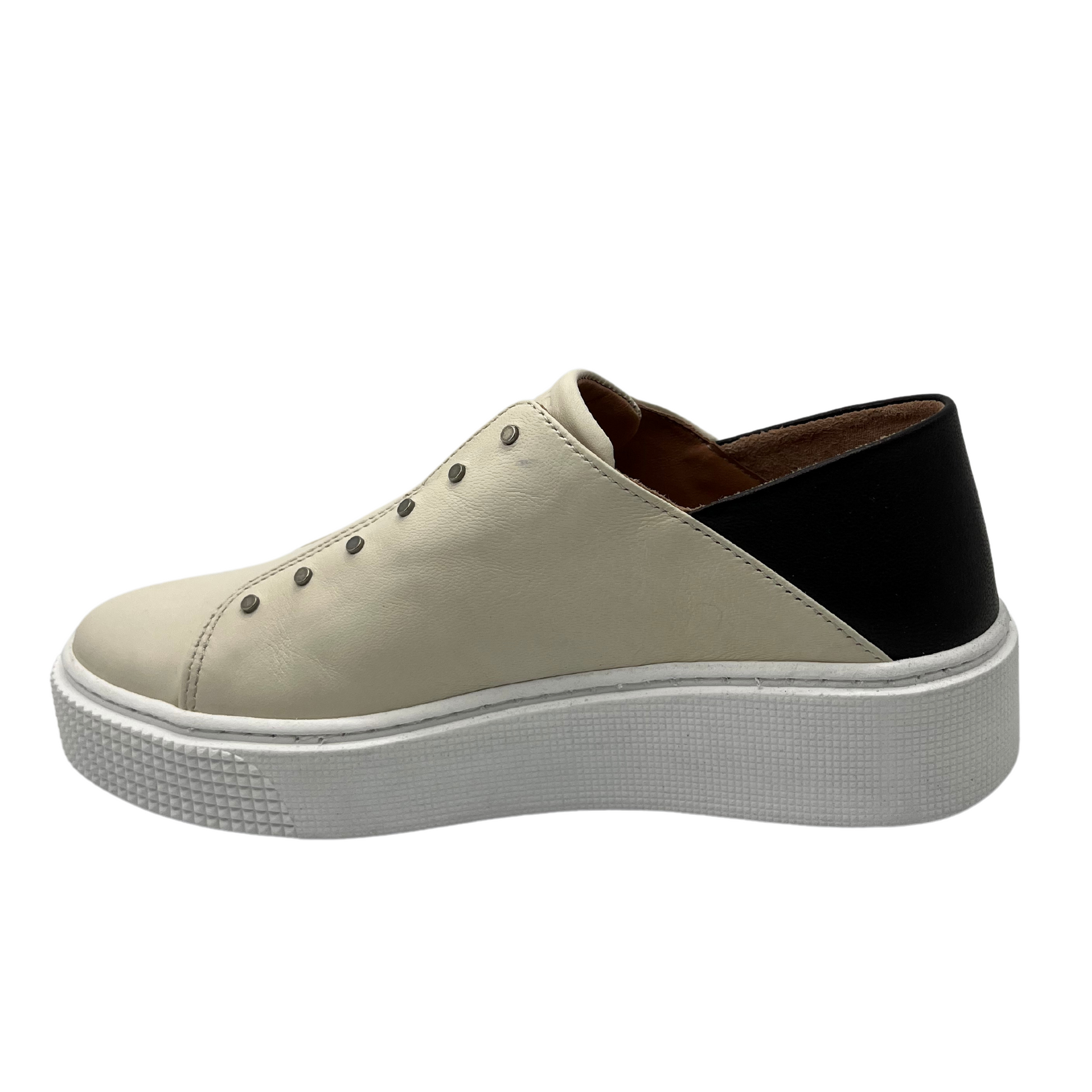 Left view of latte coloured sneaker with black heel detail and white rubber outsole
