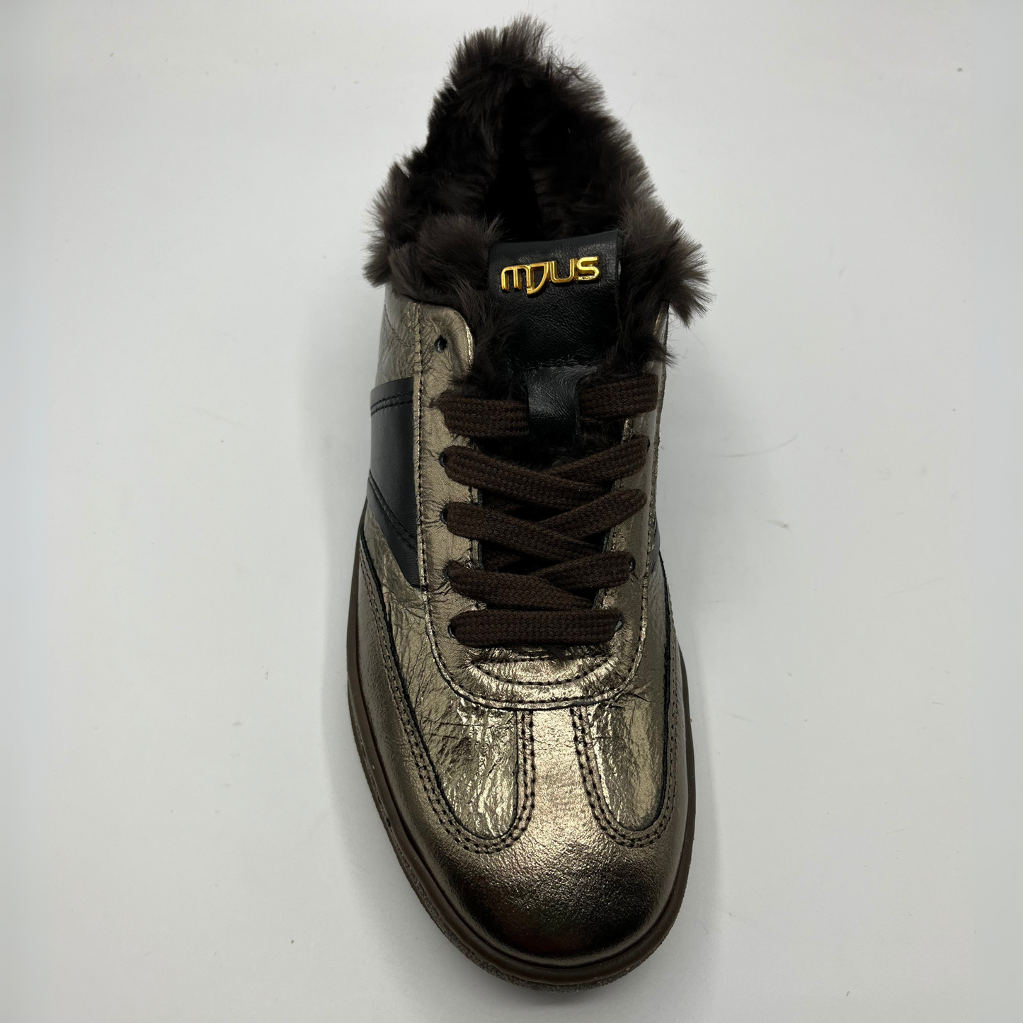 Metallic sneaker with fur lining and brown laces on a white background