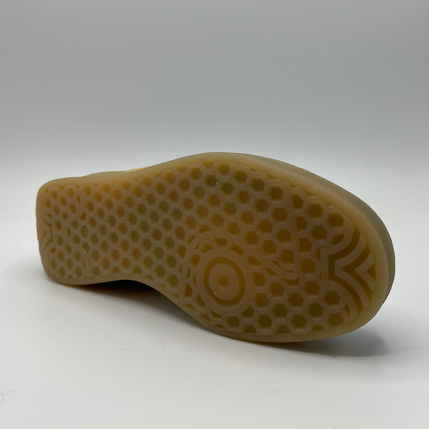 Bottom view of a retro quilted sneaker with a translucent rubber outsole.