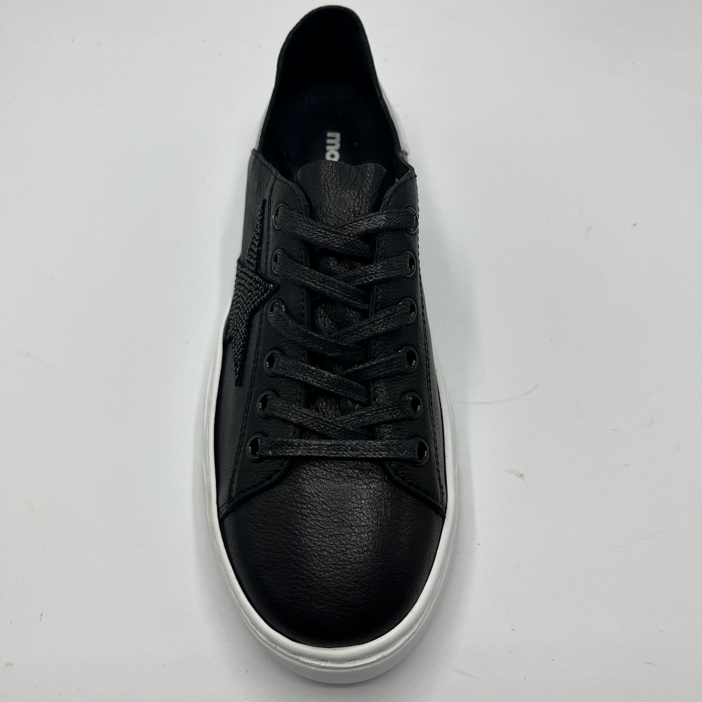 Top view of a black leather sneaker with a black bejewelled star