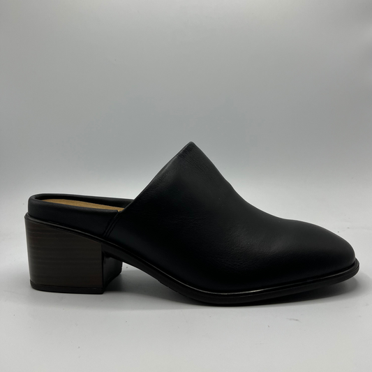 Black leather clog shoe on a light gray background