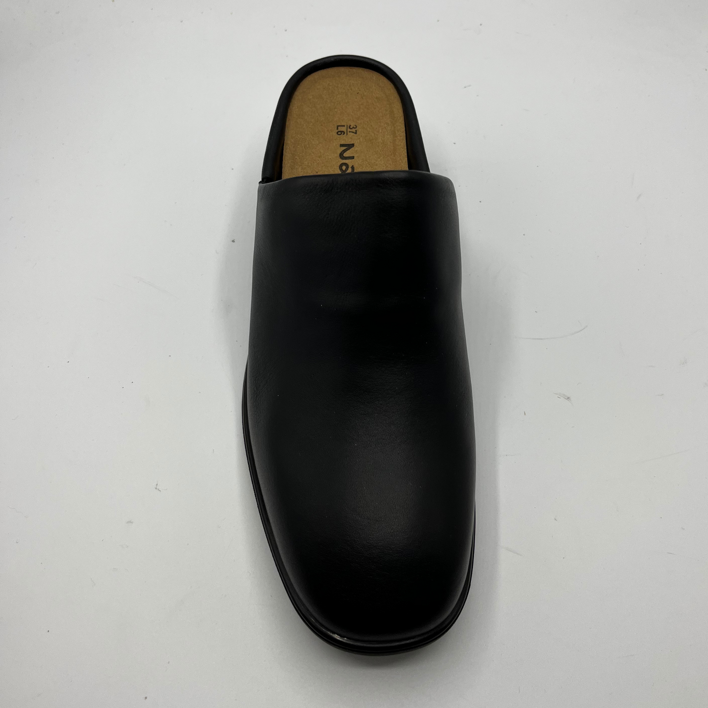 Black leather slipper on a white background