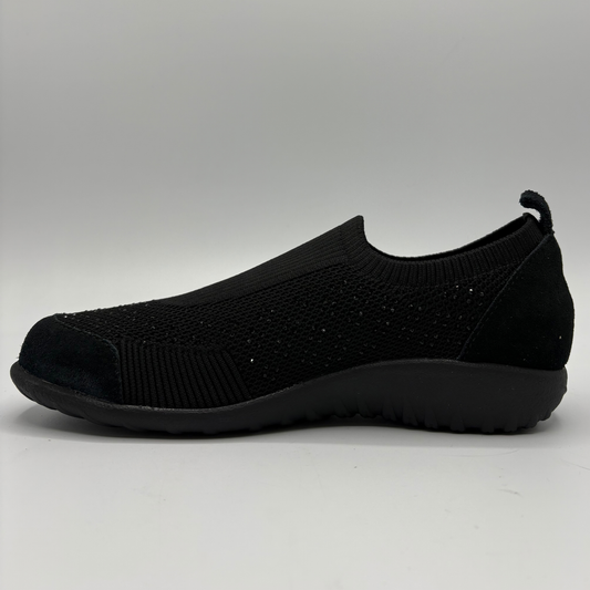 A knit shoe shown from a side profile on a white background.