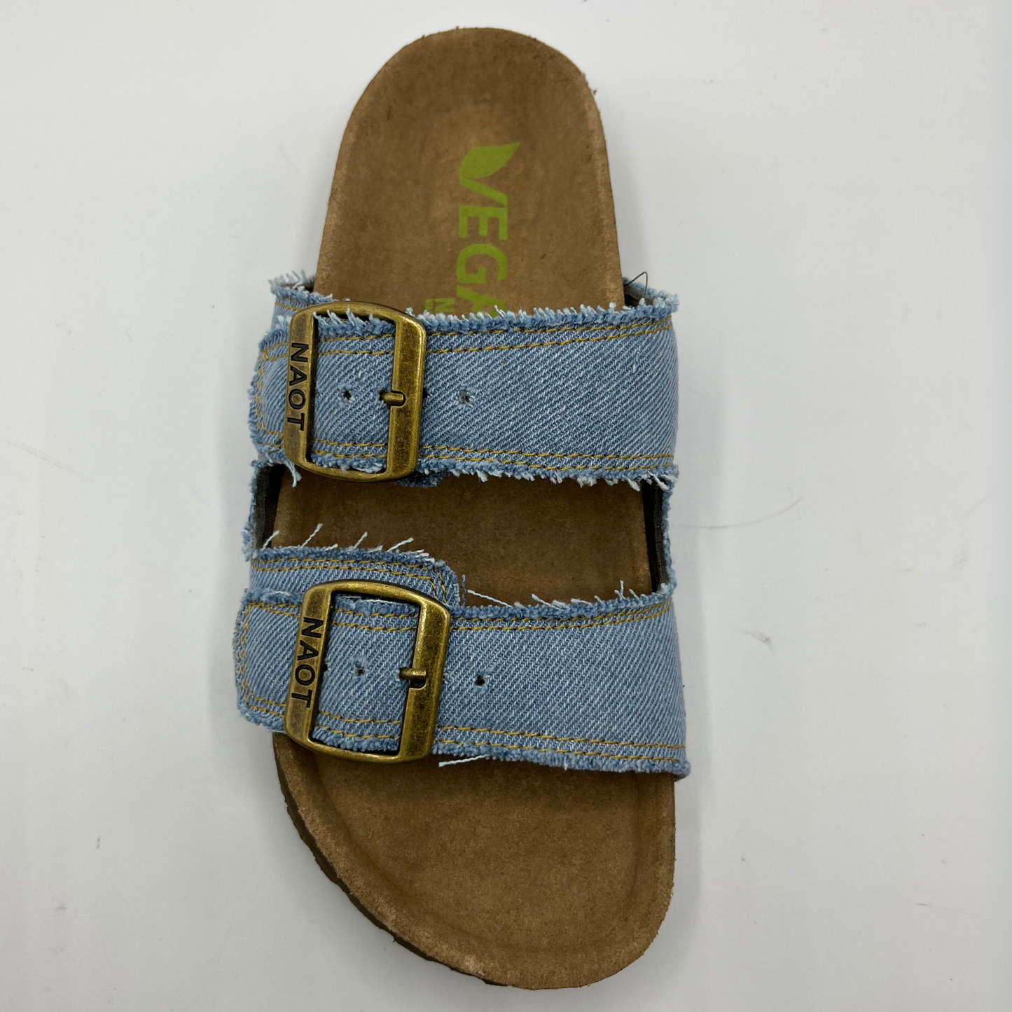 Top view of a denim slip on sandal with a contoured cork footbed and two adjustable straps.