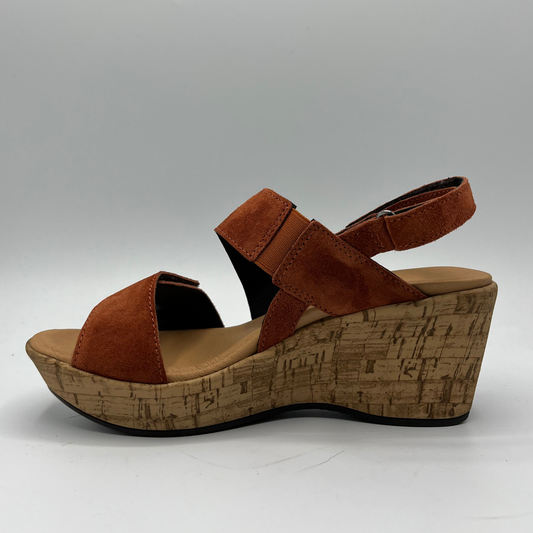 Left facing view of a suede sandal with a cushioned footed and hook and loop adjustable straps on the ankle and toe.