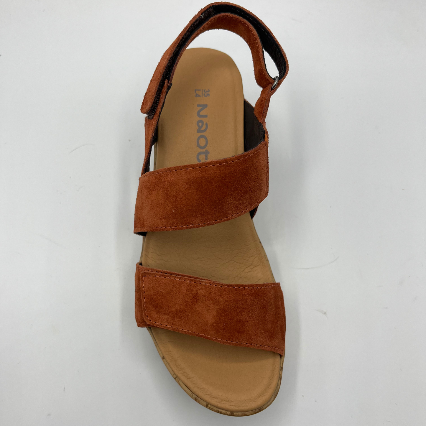Top view of a suede sandal with a cushioned footed and hook and loop adjustable straps on the ankle and toe.