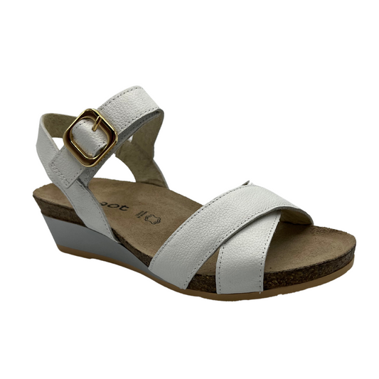 45 degree angled view of white leather strapped sandal with gold buckle and wedge heel.