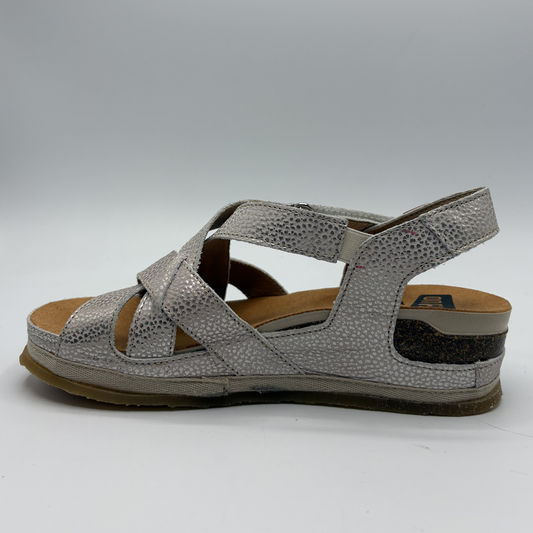 Silver sandal with criss-cross straps on a white background