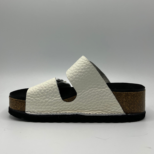 Left facing view of a platform sandal in a pebbled white leather.  Two thick straps across with adjustable buckles.