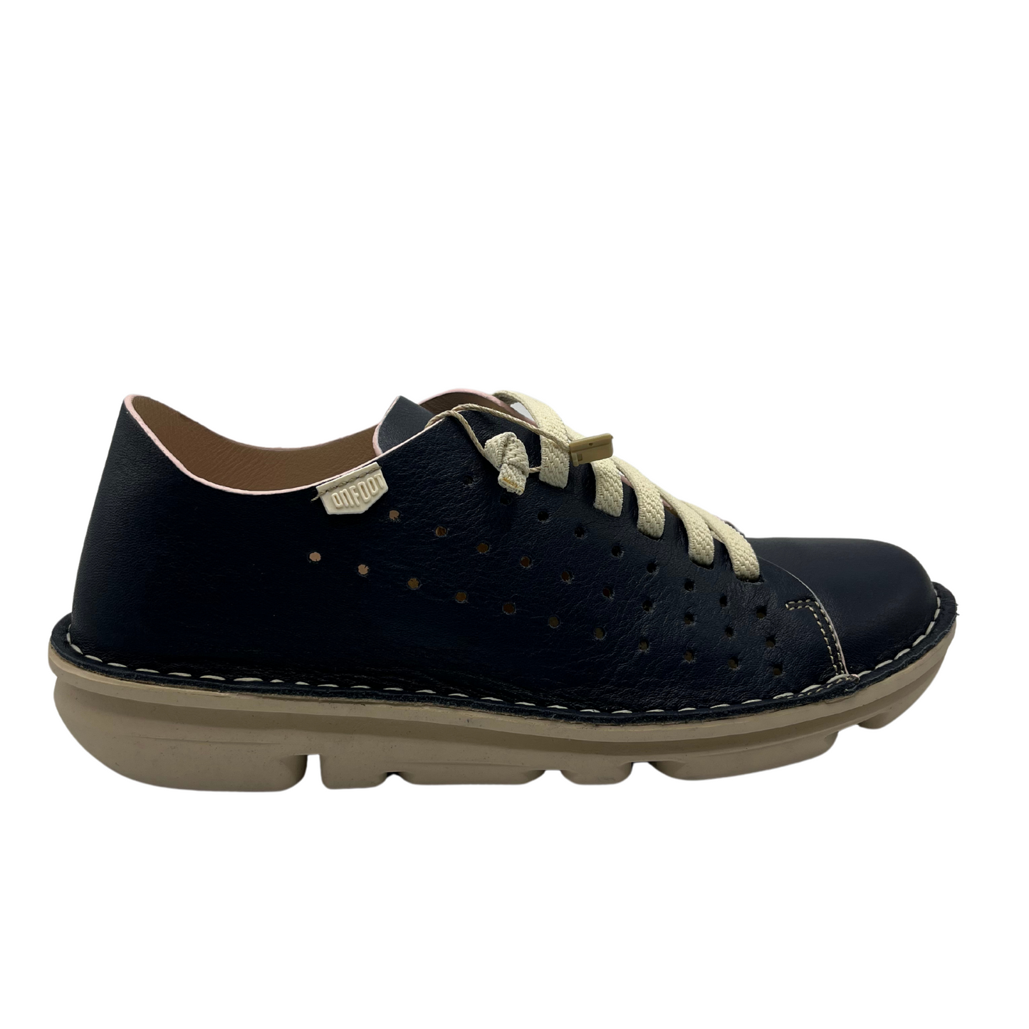 Right facing view of a navy perforated leather sneaker with cream laces and matching rubber outsole.