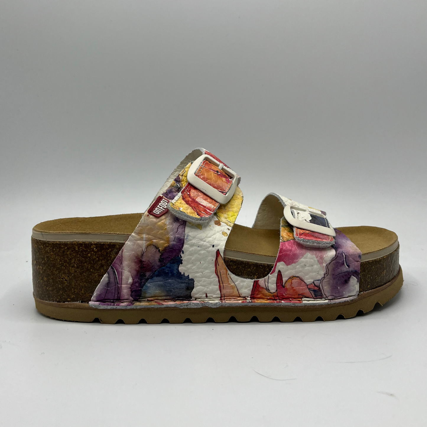 Right facing view of a leather strapped sandal with a floral watercolour pattern, two adjustable straps and a contoured footbed.