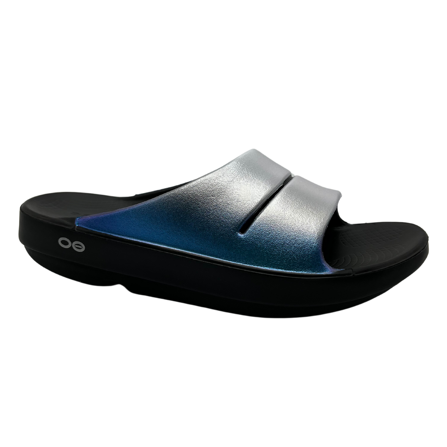 45 degree angled view of foam slip on sandal with frosty coloured iridescent straps and black outsole