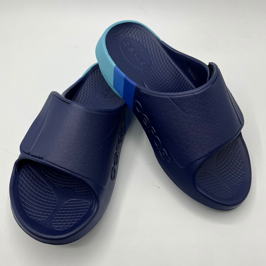 Top view of a pair of blue multi-toned foam unisex sandals with an adjustable slip on strap.