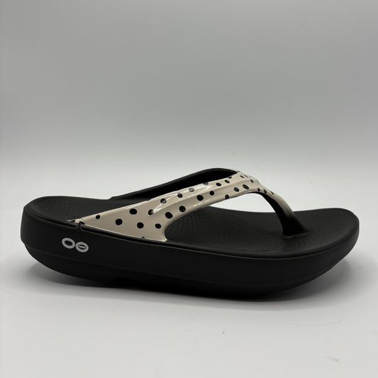 Black and beige sandal on a gray background