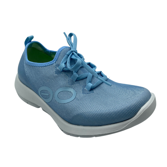 45 degree angled view of blue and white sneaker with matching blue laces and pull on tab
