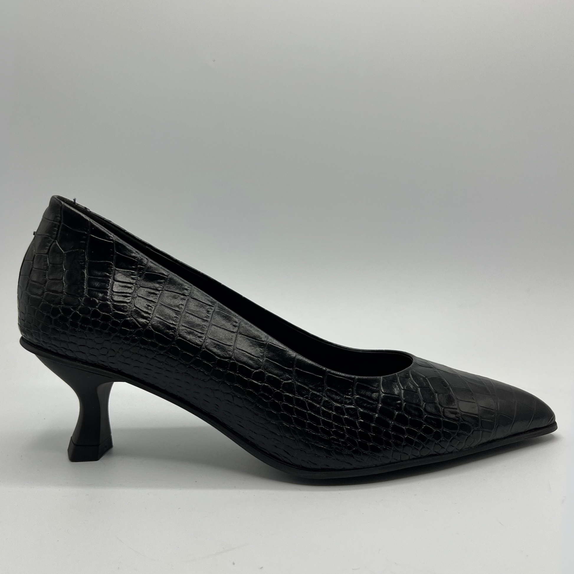 Black crocodile-patterned high heel shoe on a white background