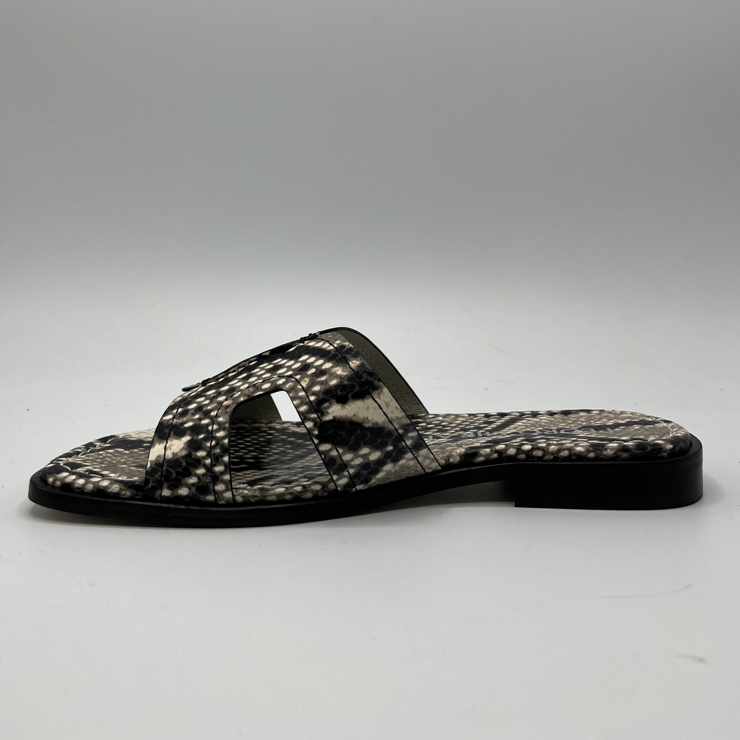 Left facing view of a snake print leather flat sandal with a leather lining and upper.