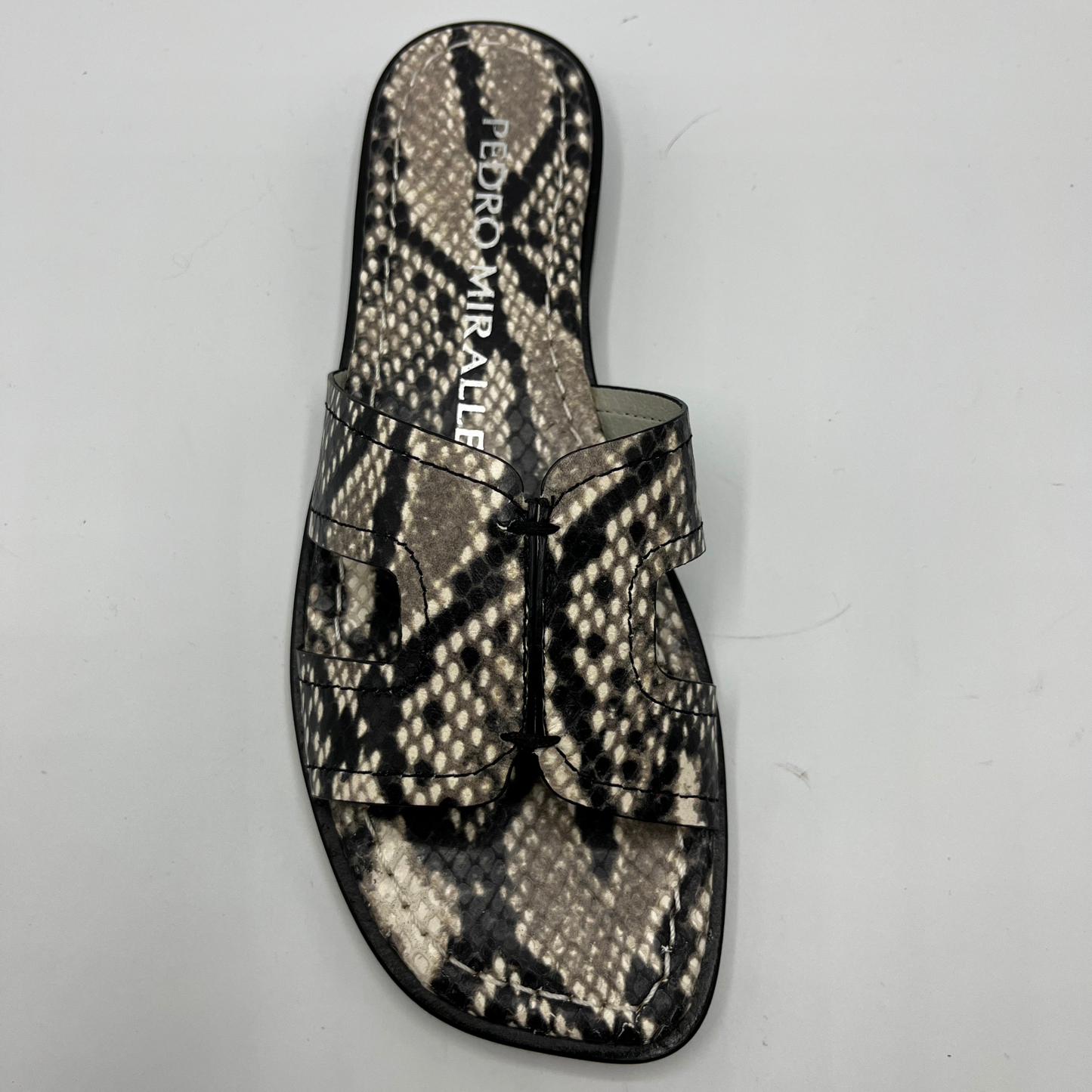 Top view of a snake print leather flat sandal with a leather lining and upper.